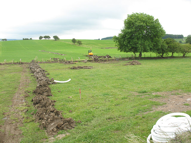 Open trench with new drainage pipe being laid